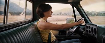 Movie still from “Lucy in the Sky” (2019), directed by Noah Hawley – A woman sitting in the driver's seat of a truck; Medium shot, Low angle