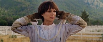 Movie still from “Lucy in the Sky” (2019), directed by Noah Hawley – A woman in a white jacket holding her hands up to her head; Close Up shot, Low angle