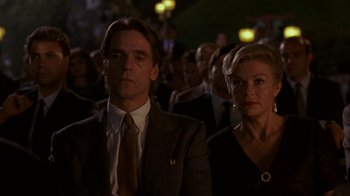Movie still from “M. Butterfly” (1993), directed by David Cronenberg – A man and a woman are standing in front of a crowd of onlookers; Close Up shot, Low angle