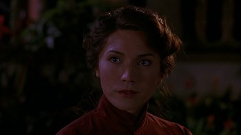 Movie still from “M. Butterfly” (1993), directed by David Cronenberg – A person wearing a red shirt; Close Up shot, Over the shoulder angle