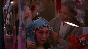 Movie still from “M. Butterfly” (1993), directed by David Cronenberg – An asian woman is getting her makeup done; Close Up shot, Over the shoulder angle