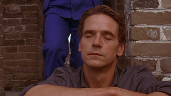 Movie still from “M. Butterfly” (1993), directed by David Cronenberg – A person with his eyes closed; Close Up shot, Low angle