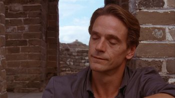 Movie still from “M. Butterfly” (1993), directed by David Cronenberg – A person with his eyes closed; Close Up shot, Over the shoulder angle