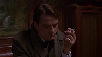 Movie still from “M. Butterfly” (1993), directed by David Cronenberg – A person smoking a cigarette; Close Up shot, Low angle