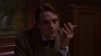Movie still from “M. Butterfly” (1993), directed by David Cronenberg – A person smoking a cigarette; Close Up shot, Over the shoulder angle