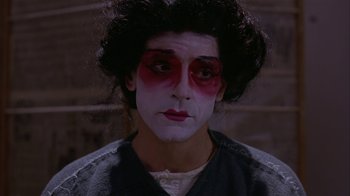 Movie still from “M. Butterfly” (1993), directed by David Cronenberg – A person with makeup on their face; Close Up shot, High angle