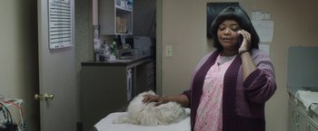 Movie still from “Ma” (2019), directed by Tate Taylor – A woman standing next to a dog in a room; Medium shot, Over the shoulder angle