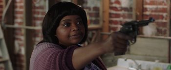 Movie still from “Ma” (2019), directed by Tate Taylor – A woman in a purple sweater is holding a camera; Close Up shot, Over the shoulder angle
