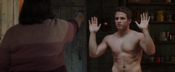 Movie still from “Ma” (2019), directed by Tate Taylor – A man with no shirt is holding his hand up to a woman; Medium shot, Over the shoulder angle