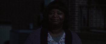 Movie still from “Ma” (2019), directed by Tate Taylor – A woman is smiling for the camera in the dark; Close Up shot, Over the shoulder angle