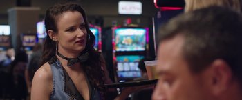 Movie still from “Ma” (2019), directed by Tate Taylor – A woman holding a tray in front of slot machines; Close Up shot, Over the shoulder angle