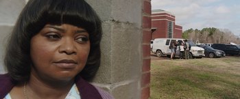 Movie still from “Ma” (2019), directed by Tate Taylor – A woman leaning against a brick wall next to a building; Close Up shot, Over the shoulder angle
