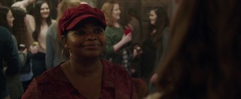 Movie still from “Ma” (2019), directed by Tate Taylor – A woman wearing a red hat is smiling for the camera; Close Up shot, Over the shoulder angle