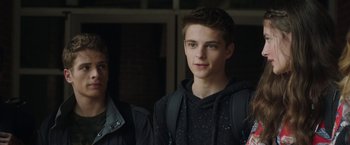 Movie still from “Ma” (2019), directed by Tate Taylor – A young man wearing a black jacket and a black backpack; Close Up shot, Over the shoulder angle