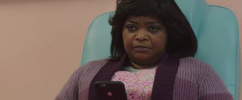 Movie still from “Ma” (2019), directed by Tate Taylor – A woman sitting in a chair looking at a cell phone; Close Up shot, Over the shoulder angle