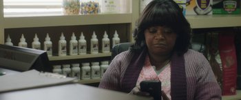 Movie still from “Ma” (2019), directed by Tate Taylor – A woman sitting at a table looking at a cell phone; Close Up shot, Over the shoulder angle