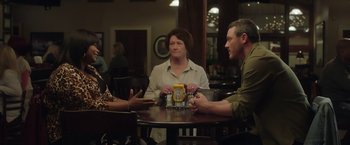Movie still from “Ma” (2019), directed by Tate Taylor – A group of people sitting around a table; Medium shot, Over the shoulder angle