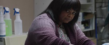 Movie still from “Ma” (2019), directed by Tate Taylor – A black woman with long black hair wearing a purple sweater; Close Up shot, Over the shoulder angle