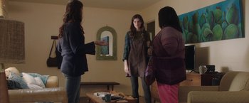 Movie still from “Ma” (2019), directed by Tate Taylor – A group of women standing around a table; Medium shot, Over the shoulder angle