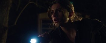 Movie still from “Ma” (2019), directed by Tate Taylor – A person with a flashlight in a dark room; Close Up shot, Over the shoulder angle