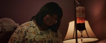 Movie still from “Ma” (2019), directed by Tate Taylor – A woman with black hair smiles for the camera; Close Up shot, Over the shoulder angle