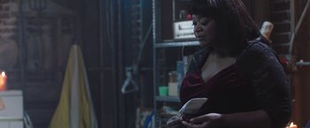 Movie still from “Ma” (2019), directed by Tate Taylor – A woman holding a cell phone in her hands; Medium shot, Over the shoulder angle