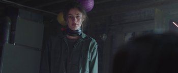 Movie still from “Ma” (2019), directed by Tate Taylor – A young woman wearing a green jacket and a purple paper lantern; Close Up shot, Over the shoulder angle