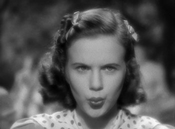 Movie still from “Mad About Music” (1938), directed by Norman Taurog – An old photo of a woman with a bow in her hair; Close Up shot, High angle