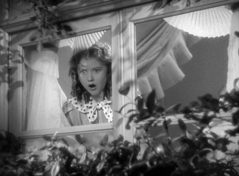 Movie still from “Mad About Music” (1938), directed by Norman Taurog – A young girl looking out of a window; Medium shot, Low angle