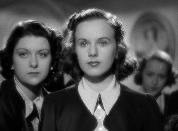 Movie still from “Mad About Music” (1938), directed by Norman Taurog – Two young women standing next to each other in front of a wall; Close Up shot, Low angle