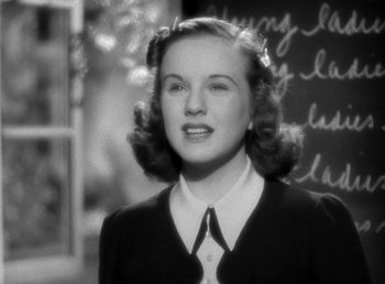 Movie still from “Mad About Music” (1938), directed by Norman Taurog – An old photo of a young woman in a school uniform; Close Up shot, Low angle