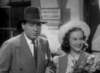 Movie still from “Mad About Music” (1938), directed by Norman Taurog – A man and a woman standing next to each other; Medium shot, Low angle