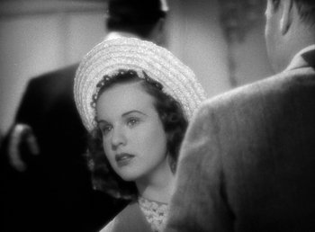 Movie still from “Mad About Music” (1938), directed by Norman Taurog – A black - and - white photo of a woman wearing a hat; Close Up shot, High angle
