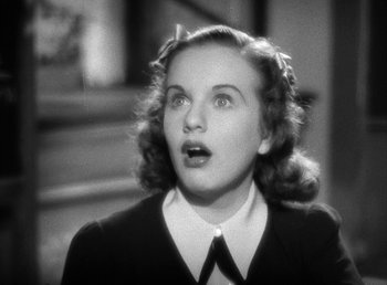 Movie still from “Mad About Music” (1938), directed by Norman Taurog – An old black and white photo of a woman looking surprised; Close Up shot, High angle