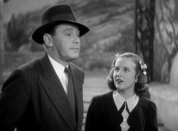 Movie still from “Mad About Music” (1938), directed by Norman Taurog – An old photo of a man and a young woman; Medium shot, Low angle