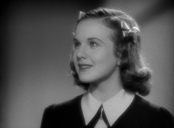 Movie still from “Mad About Music” (1938), directed by Norman Taurog – A young woman in a black and white photo; Close Up shot, Low angle