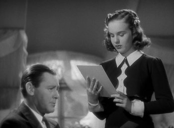 Movie still from “Mad About Music” (1938), directed by Norman Taurog – An old photo of a man and a young woman looking at a piece of paper; Close Up shot, Low angle