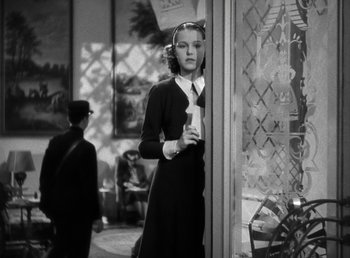 Movie still from “Mad About Music” (1938), directed by Norman Taurog – A woman standing in front of a store window; Medium shot, Low angle