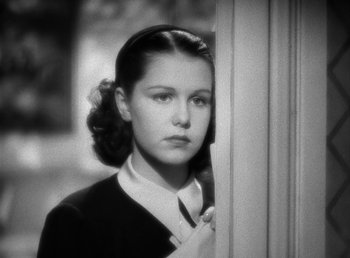 Movie still from “Mad About Music” (1938), directed by Norman Taurog – A young woman standing in front of a window; Close Up shot, Low angle