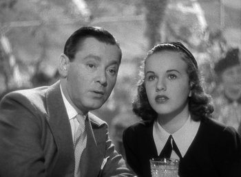 Movie still from “Mad About Music” (1938), directed by Norman Taurog – An older man and a young woman posing for a picture; Close Up shot, Low angle