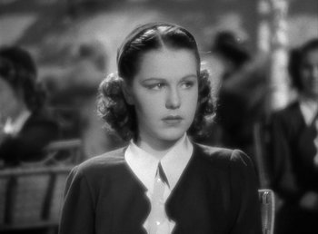 Movie still from “Mad About Music” (1938), directed by Norman Taurog – An old photo of a woman in a suit and tie; Close Up shot, High angle
