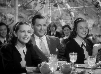 Movie still from “Mad About Music” (1938), directed by Norman Taurog – A group of people sitting at a table with drinks; Medium shot, Low angle