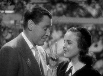 Movie still from “Mad About Music” (1938), directed by Norman Taurog – A man and a woman standing next to each other; Close Up shot, High angle