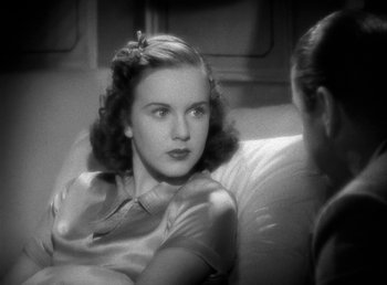 Movie still from “Mad About Music” (1938), directed by Norman Taurog – A woman sitting on a couch talking to another woman; Close Up shot, High angle