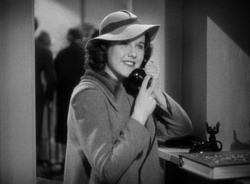 Movie still from “Mad About Music” (1938), directed by Norman Taurog – A black and white photo of a woman talking on a phone; Close Up shot, High angle