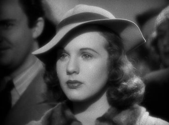 Movie still from “Mad About Music” (1938), directed by Norman Taurog – A black and white photo of a woman wearing a hat; Close Up shot, Low angle
