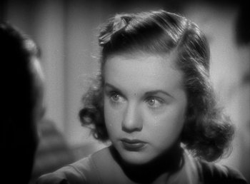 Movie still from “Mad About Music” (1938), directed by Norman Taurog – A woman with a bow in her hair looking at the camera; Close Up shot, High angle