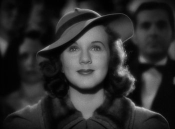 Movie still from “Mad About Music” (1938), directed by Norman Taurog – An old photo of a woman wearing a hat; Close Up shot, Low angle