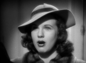 Movie still from “Mad About Music” (1938), directed by Norman Taurog – A black and white photo of a woman wearing a hat; Close Up shot, Low angle