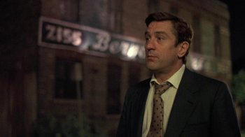 Movie still from “Mad Dog and Glory” (1993), directed by John McNaughton – A person wearing a suit and a tie; Close Up shot, Low angle